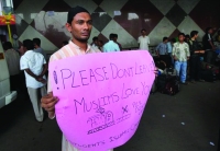 A man holding pluck card with peace message